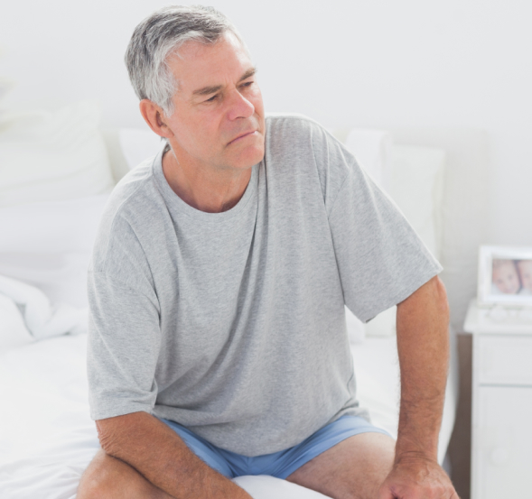 man sitting on a bed